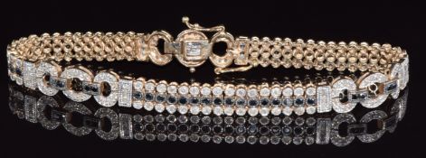 A 9ct gold tennis bracelet set with diamonds and black diamonds in three rows with buckle