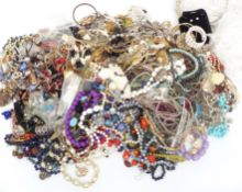 A collection of costume jewellery including vintage brooches, beads, necklaces, etc