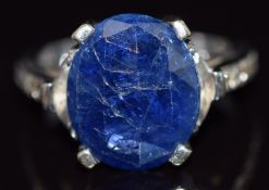 An 18k white gold ring set with a sapphire and diamonds to the shoulders and mount, 8.3g, size K/L