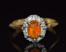 An 18ct gold ring set with an oval cut citrine and diamonds, 3.2g, size L