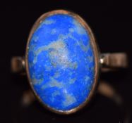 A c1900 yellow metal ring set with an oval sodalite cabochon, 4.5g, size L