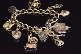 A 9ct gold charm bracelet with eight 9ct gold charms including a moving cuckoo clock, etc, 25.3g