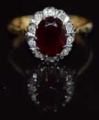 An 18ct gold ring set with paste surrounded by diamonds, 4.3g, size L/M