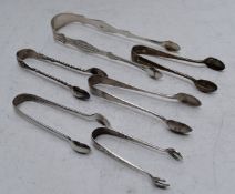 Six pairs of hallmarked silver sugar tongs to include a Georgian bright cut pair, length of