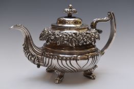 William IV hallmarked silver teapot with ornate embossed floral decoration and reeded lower body,