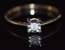 A 9ct gold ring set with a diamond in an illusion setting, 1.2g, size O