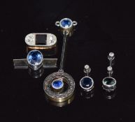 A 15ct gold pendant set with two sapphires with a platinum finish, three mounted sapphires and a