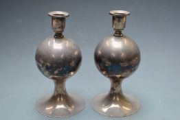 A pair of unusual white metal / silver plated continental candlesticks of globular form, impressed