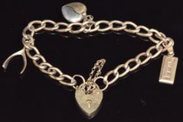 A 9ct gold charm bracelet with an ingot, wishbone and heart charm, 12g