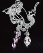 Two 10k white gold pendants, one set with pink sapphires and the other diamonds, on 10k white gold
