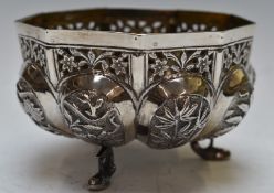 Indian or Burmese white metal bowl with lobed and embossed decoration, raised on three fish feet,