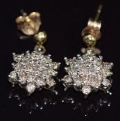 A pair of 9ct gold earrings set with diamonds in a cluster, 2.3g