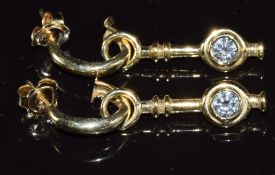 A pair of 14ct gold earrings set with diamonds of approximately 0.38ct & 0.3ct