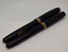 Two Conway Stewart 58 fountain pens, both with 14ct gold nibs and yellow metal fittings.