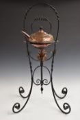 In the manner of W.A.S. Benson Arts and Crafts copper spirit kettle on wrought iron stand, H73cm