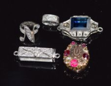 Three diamond clasps, a ruby and diamond horseshoe and another clasp
