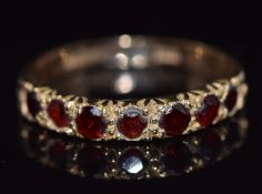 A 9ct gold half eternity ring set with garnets, 2.3g, size J