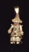 A 9ct gold pendant in the form of a clown set with an emerald, ruby, sapphire and paste, 6.5g