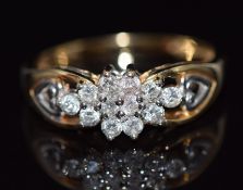 A 9ct gold ring set with diamonds in a cluster, total diamond weight approximately 0.5ct, 3.6g, size
