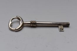 Modern novelty hallmarked silver key ring formed as a spring loaded key, London Ari D Norman, length