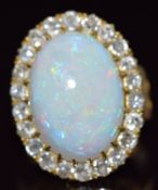 Victorian 18ct gold ring set with an oval opal cabochon of approximately 7cts surrounded by old