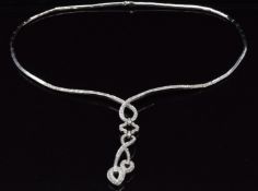 An 18ct white gold necklace set with round cut diamonds in a twist drop design, 38g