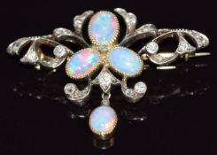 A c1910 gold brooch set with oval opal cabochons and old cut diamonds, 4.9g, 3.7cm long