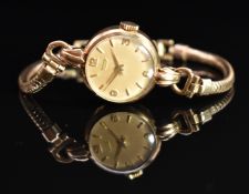 Tissot 9ct gold ladies wristwatch with gold hands and Arabic numerals, champagne dial and signed