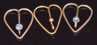 A 9ct gold heart shaped clip (0.5g) and two yellow metal tie/ collar clips set with a Montana