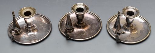 A set of three plated chambersticks with snuffers, diameter 15cm
