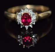 A 9ct gold ring set with a synthetic ruby surrounded by diamonds, 2g, size O
