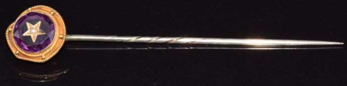 Victorian stick pin set with an amethyst with a seed pearl inset to the centre