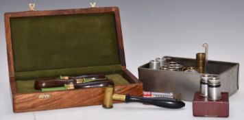 A collection of shotgun tools and accessories including a cased set of three turned mahogany