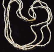 A three strand pearl necklace