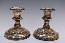 Edward VII pair of hallmarked silver candlesticks with gadrooned decoration, Birmingham 1906,