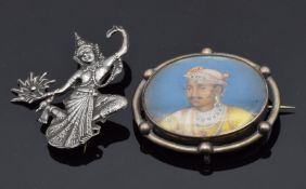 A silver brooch set with an Indian portrait and a Siam silver brooch