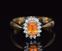 A 9ct gold ring set with an emerald cut fire opal surrounded by diamonds, 3g, size N