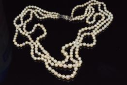 A three strand cultured pearl necklace with silver clasp