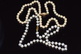 Two single strand cultured pearl necklaces, both with 9ct gold clasps