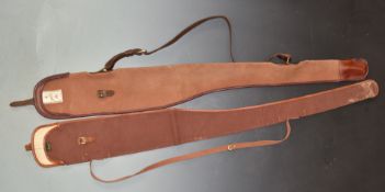 Two vintage gun slips, one Holland and Holland the other Brady, both with original labels.