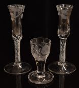 A pair of mid-18thC air twist stem glasses, the bowls etched with roses of Jacobean significance,