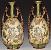 A pair of Vienna twin handled pedestal vases with tube lined decoration of Meconopsis / Himalayan