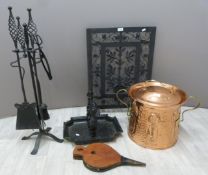 Art Nouveau copper covered coal scuttle, foot scraper, Arts & Crafts companion set and a fire guard