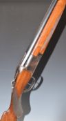 Miroku 12 bore over and under shotgun with border engraved lock, chequered semi-pistol grip and