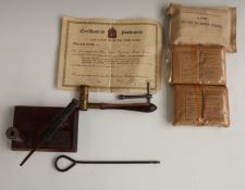 Desk top pen holder with a swivel gun adornment, shot measuring tool, three first field dressings