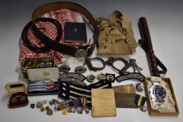Palestine Police ephemera including leather belt with buckle, truncheon, handcuffs, buttons of