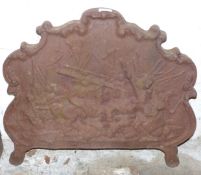 Antique cast iron fireback with relief decoration of mounted riders in a battle scene, Fladbury