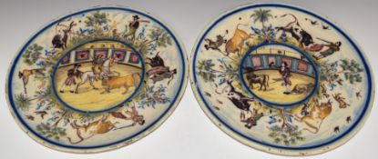 Pair of 19thC Spanish chargers decorated with bullfighting scenes, diameter 36.5cm