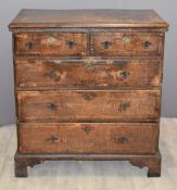 18th/19thC oak chest of two over three drawers with crossbanded and feathered decoration, raised
