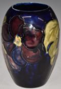 Moorcroft vase decorated in the Clematis pattern on blue ground, H13cm